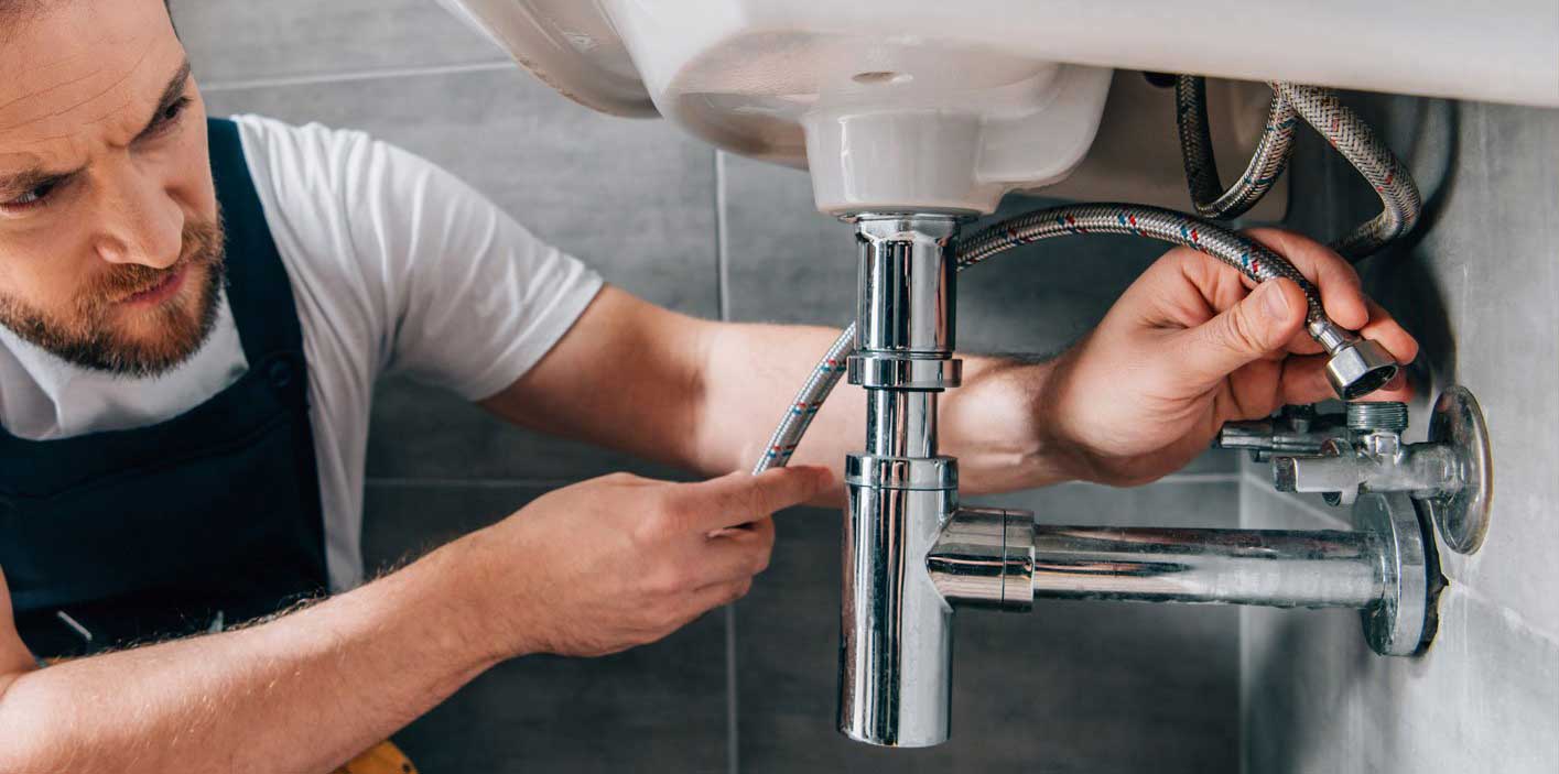 Houston plumber from Kintex Plumbing repairing a home plumbing system